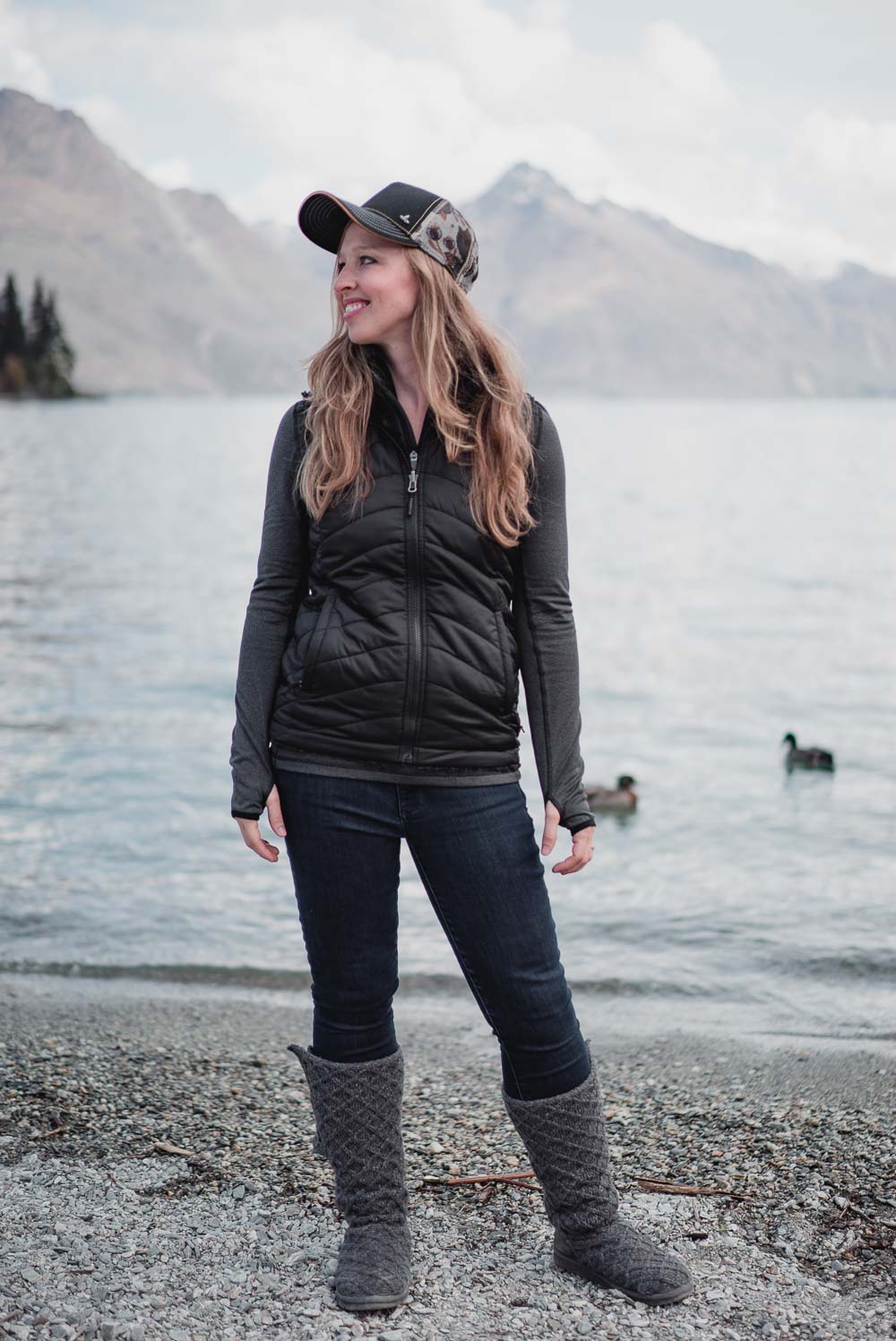 Cozy and Cute Camping Outfit on Stylish Travel Girl: Prana hat, North Face reversible vest, ICEWEAR top, GAP jeans, UGG Classic Cardy boots