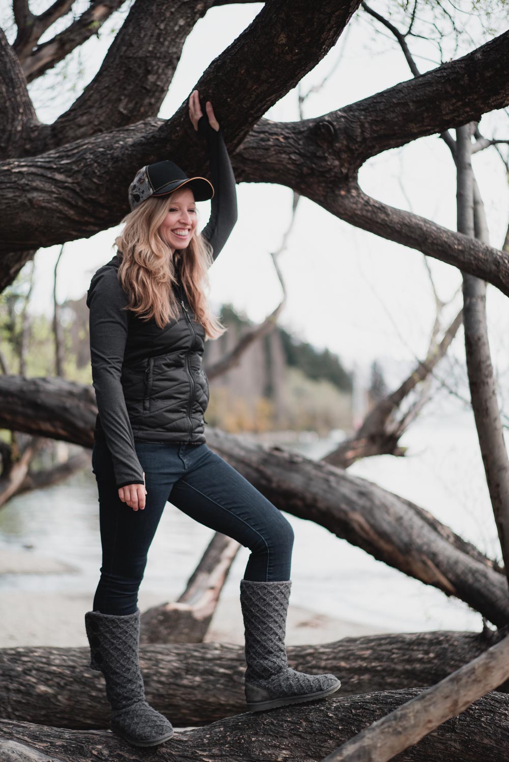 Cozy and Cute Camping Outfit on Stylish Travel Girl: Prana hat, North Face reversible vest, ICEWEAR top, GAP jeans, UGG Classic Cardy boots